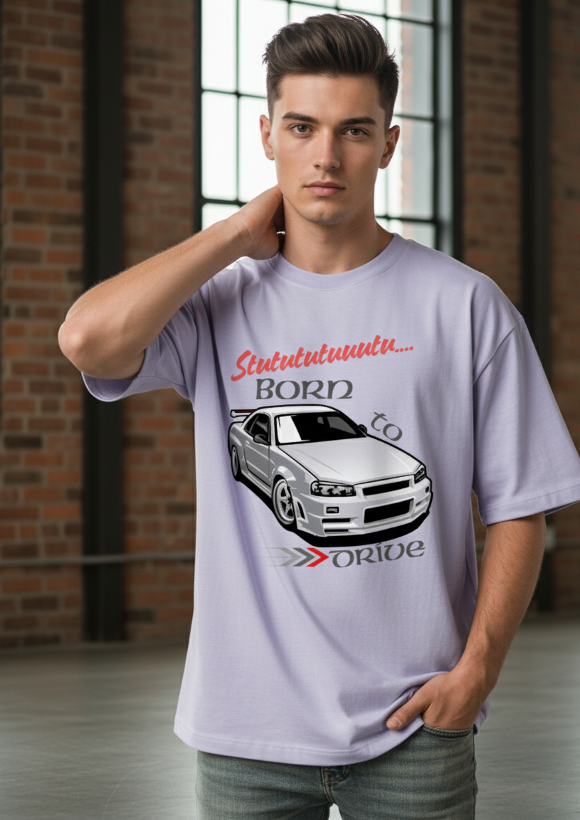 Man wearing a lavender t-shirt with a car graphic and text in an indoor setting.