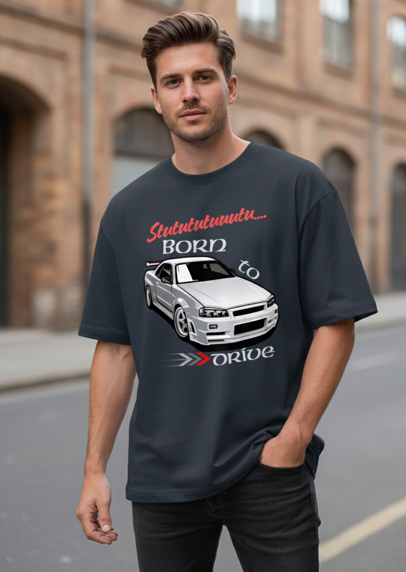 Man wearing a navy blue t-shirt with a graphic design and text, standing on a street.