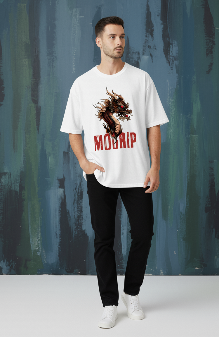 Man wearing a white t-shirt with a graphic design and text, standing against a textured wall.